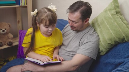 child with his father read an interesting book laugh, kid studies school homework remotely with dad, little girl laughs with daddy over fairy tale, world knowledge and miracles, dream imaginations