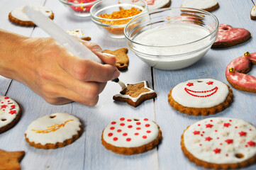 Decorating of Christmas homemade gingerbread cookies.