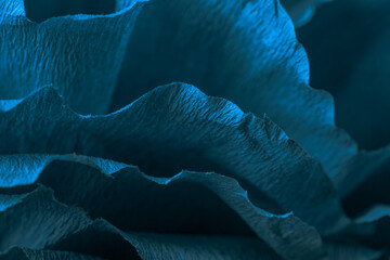 Fragment of a turquoise flower made of crepe paper. Macro photography