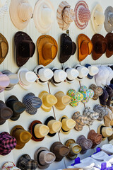 Many summer hats in shop. Head protection in hot weather. Gift shop. Equipment for summer