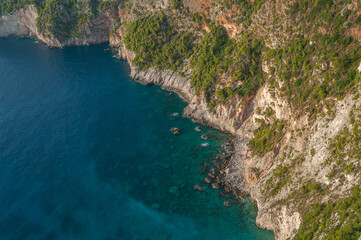 Top view of turquoise sea at the foot of cliffs in the rocky coast of Zakynthos island, Greece
