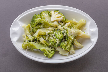 Gray background .Broccoli salad with garlic in olive oil .