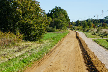 gravel road leveling in rural areas with the help of a grader