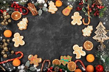 Christmas new year background, traditional festive gingerbread and tangerines with fir branches, cones and decorations, dish design idea, bakery concept,