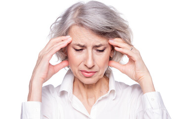 Portrait of an old but modern trendy woman suffering from a headache or migraine holding her head in her hands with a desperate expression and screaming from pain isolated on white background