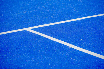 serving lines of a blue artificial grass paddle tennis court