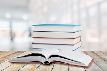 Hardcover law books stacked on wooden table on blur room background, Law Office, pile of books
