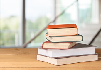 Hardcover law books stacked on wooden table on blur room background, Law Office, pile of books