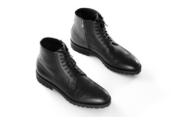 A pair of black leather men's boots, Full brogue, luxury men's shoes, fashion, casual boots, winter boots, white isolated background, product photography
