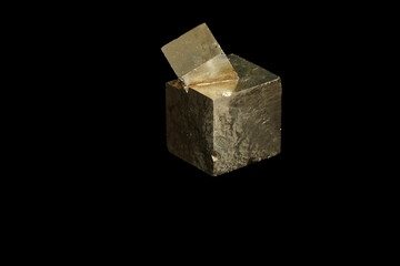 Macro mineral stone Pyrite on a black background