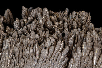 Macro of a stone Stibnite mineral on a black background