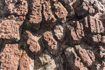 texture of red rocks eroded by the passage of time located in the desert on a sunny day illuminated by natural light