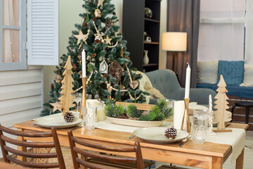 There is a Christmas table, setting in natural style