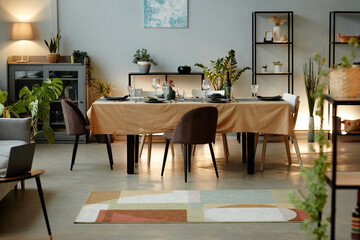 Background image of modern living room with dinner table served for party in elegant interior, copy space