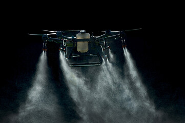 large agricultural drone sprays on a black background, streams of drops are sprayed - obrazy, fototapety, plakaty