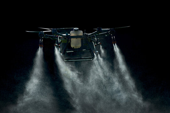 large agricultural drone sprays on a black background, streams of drops are sprayed