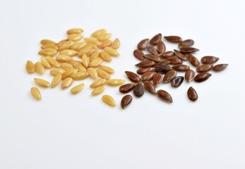 Brown and golden flax seeds on white background, close up