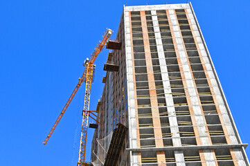 Crane and highrise construction site