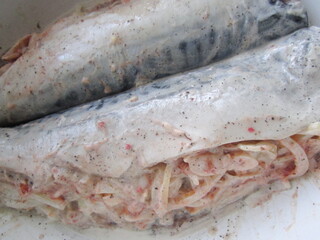 fish stuffed with vegetables and sauce prepared for baking