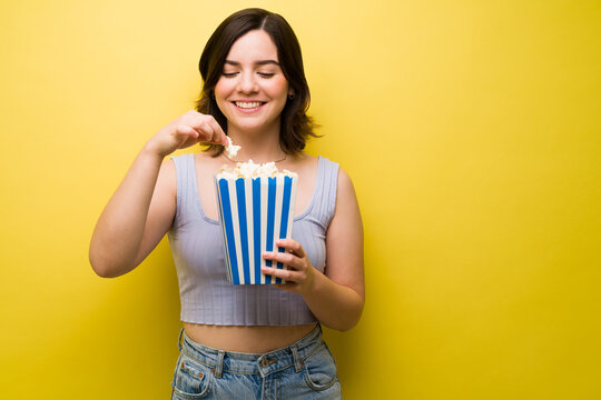 Cheerful Woman Enjoying Popcorns At The Movies