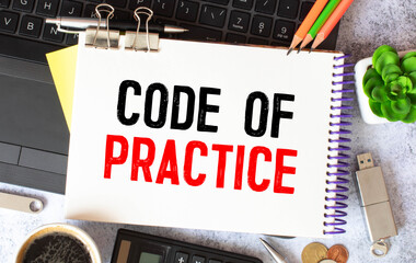 Code of Practice text written on a notebook with pencils