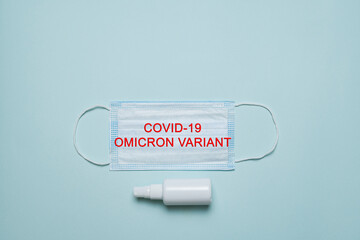 Face medicine mask with inscription Covid-19 Omicron variant. New Variant of the Covid-19 Omicron...
