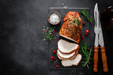 Christmas turkey ham roasted for festive dinner on black background. Top view