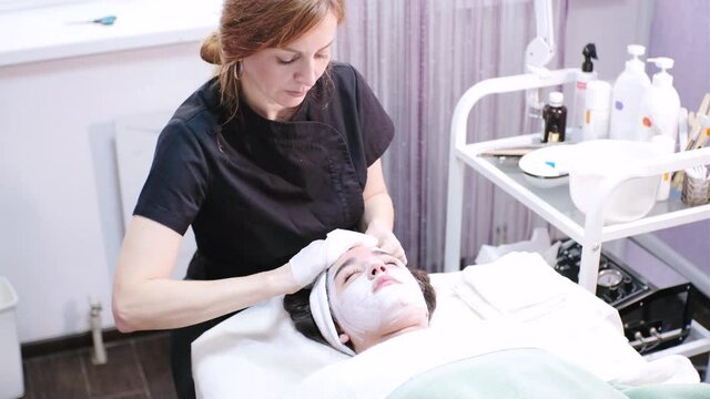 Skin cleansing in spa salon. Asian young woman lies on cosmetology procedures at the beautician. Skin care, cleansing and moisturizer, spa concept