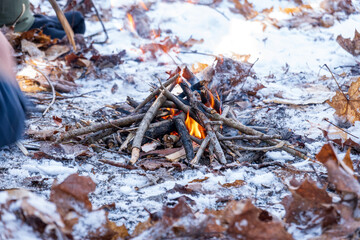 Building a campfire in the snowy woods is good skill to have, and a lot of fun to do.