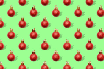 Christmas New Year holiday creative minimal seamless pattern green background with red baubles balls decorations, ornaments, Flat lay, top view