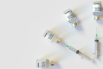 Clock face made with tetanus vaccine vials and syringes. Vaccination time concept. Conceptual medical 3D rendering