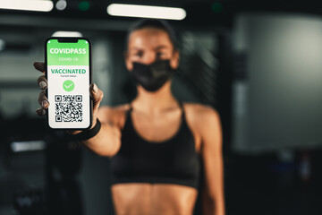 Woman Showing Her Vaccine Passport While Entering The Gym