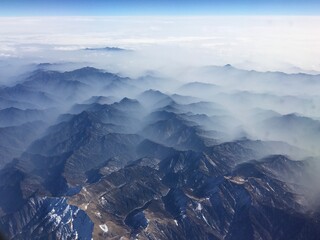 An atmospheric and epic view on the misty mountains covered with cloud layer in China
