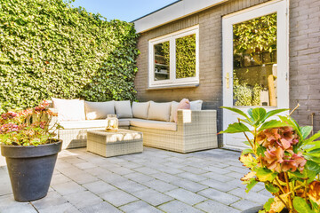 The courtyard of the house with a soft beige sofa
