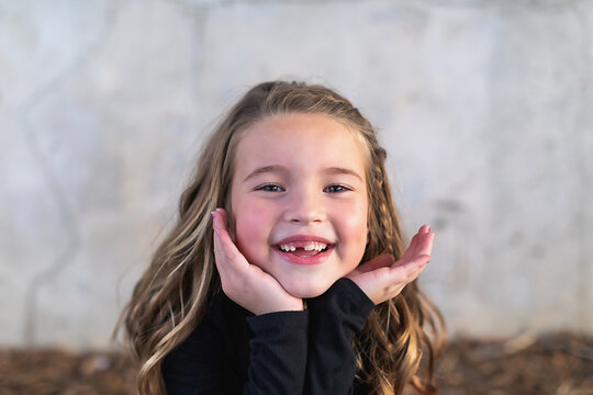 Close up photo of a smiling 7 year old girl.