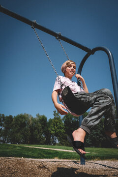 Happy Boy on a Swing on a Sunny Afternoon