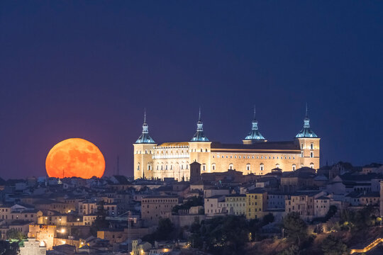 Full moon  over old town. Historical castle, Alcazar of Toledo
