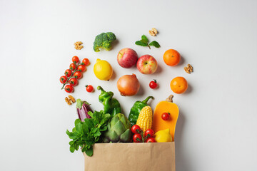 Delivery healthy food background. Healthy vegan vegetarian food in paper bag vegetables and fruits on white. Shopping food supermarket and clean vegan eating concept