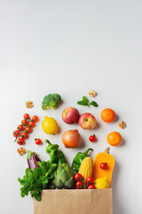 Delivery healthy food background. Healthy vegan vegetarian food in paper bag vegetables and fruits on white, copy space, banner. Shopping food supermarket and clean vegan eating concept