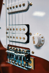 Electric guitar soundboard close up. Bridge, pickups and volume knob close-up
