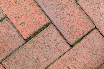 Sidewalk laying. Grunge brick background with moss. Brickwork vintage background. Rustic brick...