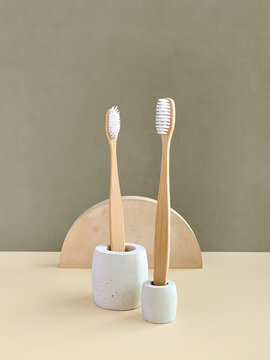 Bamboo toothbrushes in concrete stands, geometric shape props