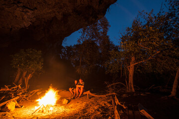 mature couple enjoying camp fire in Laos