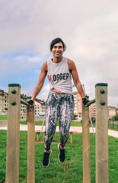 Athlete woman training on parallel bars