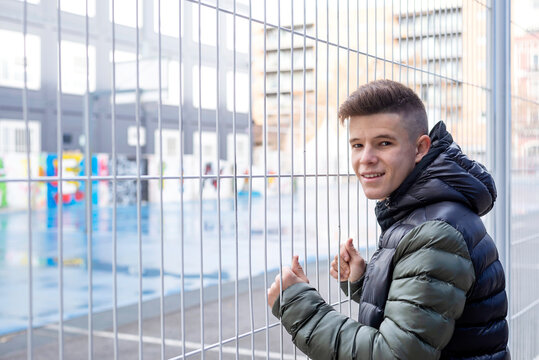 Rear View Of Man Standing By Fence