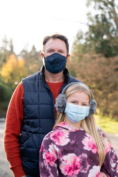 Man and Young Girl with Face Masks Outdoors on a Fall Day in Seattle