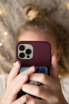 Close up of Teen/Tween Girl Laying Down Holding Mobile Phone
