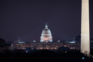 The US Capitol building and the Washington Monument at night.