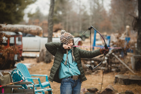 Teen girl shooting practice bow in Wisconsin