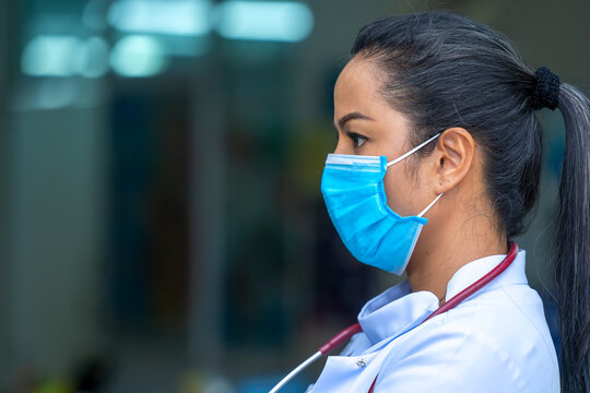 Female doctor wearing protective mask to Protect Against Covid-1